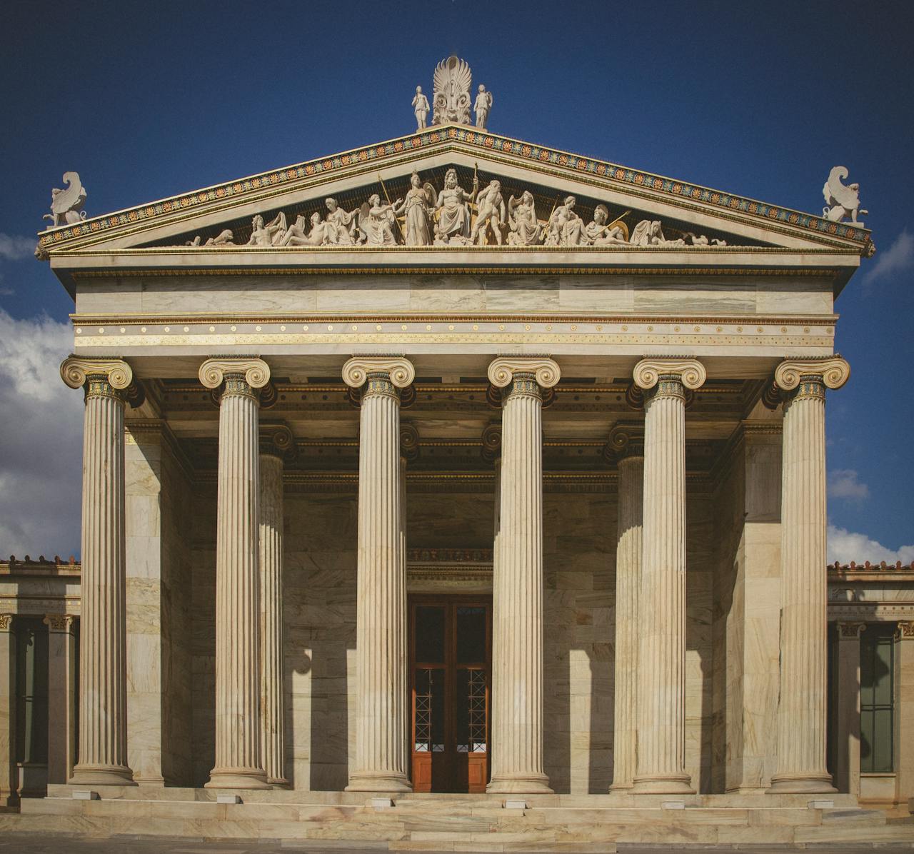 Stunning neoclassical facade with columns in sunny Athens, Greece.